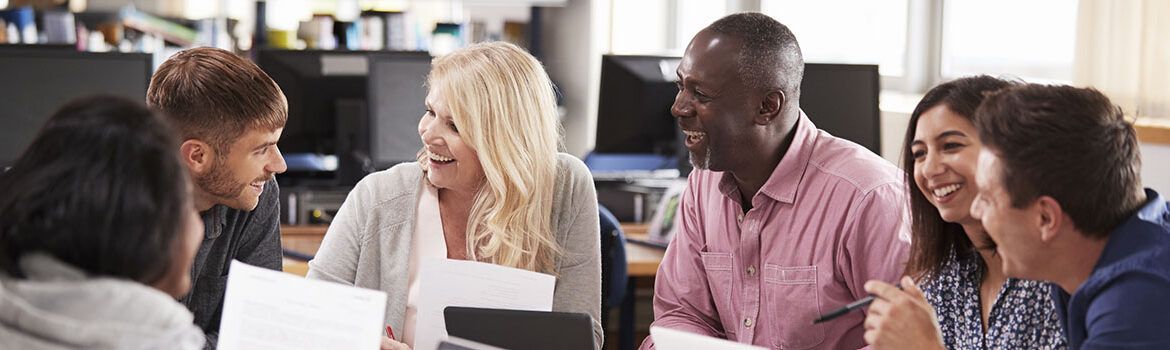 Students at the table interacting - A Practical Guide Apprenticeships