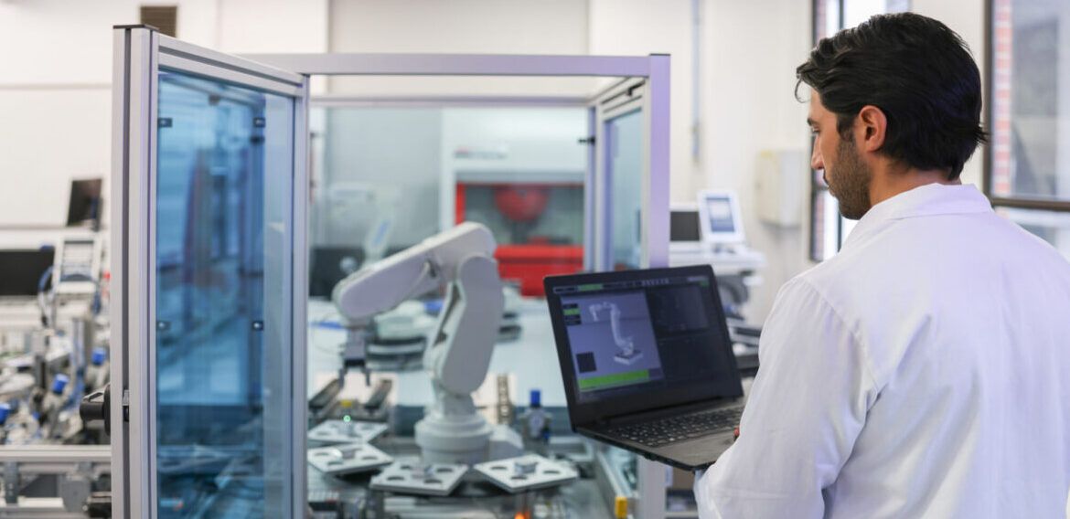 Teacher in a STEM class at the lab developing a robotic arm