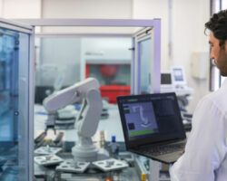 Teacher in a STEM class at the lab developing a robotic arm