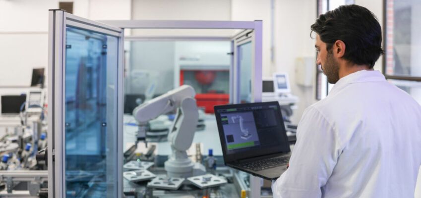 Teacher in a STEM class at the lab developing a robotic arm