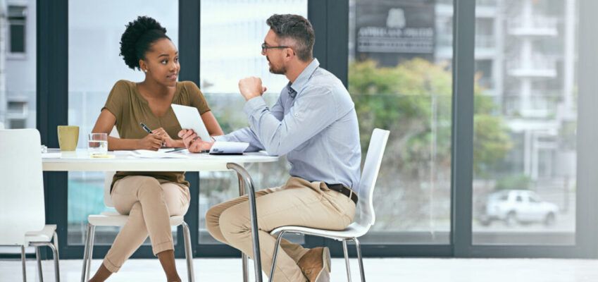 male and female talking at a table about careers services