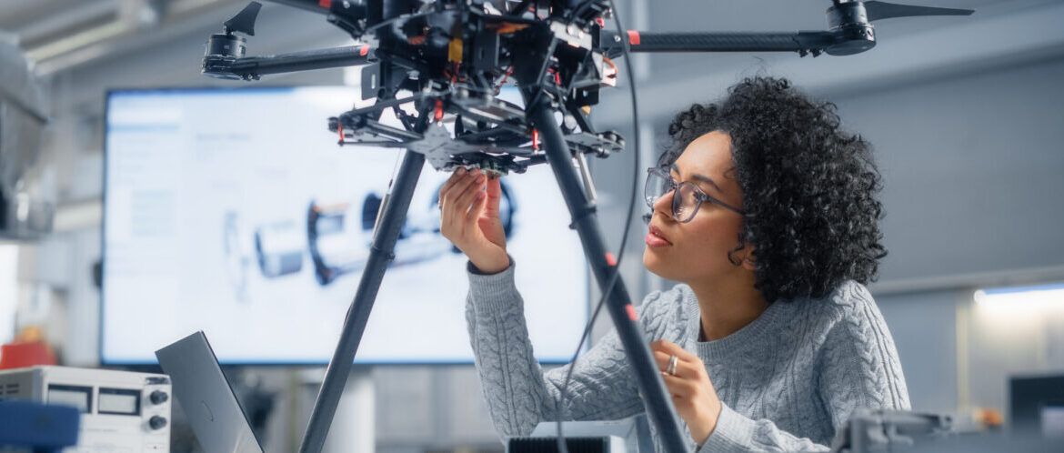 Female Engineer Writing Code. Developing Software for Modern Drone Control in the Research Center Laboratory. Technological Breakthrough in Flight Industries Concept.