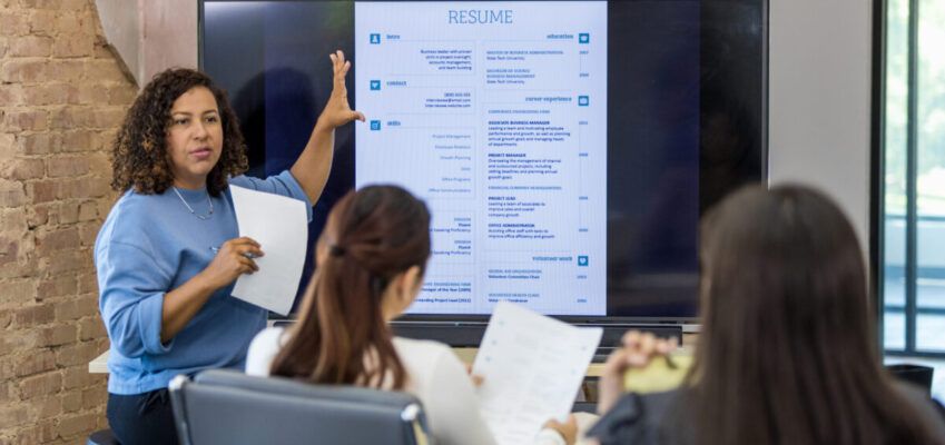 Mid adult human resources representative leads a resume building class