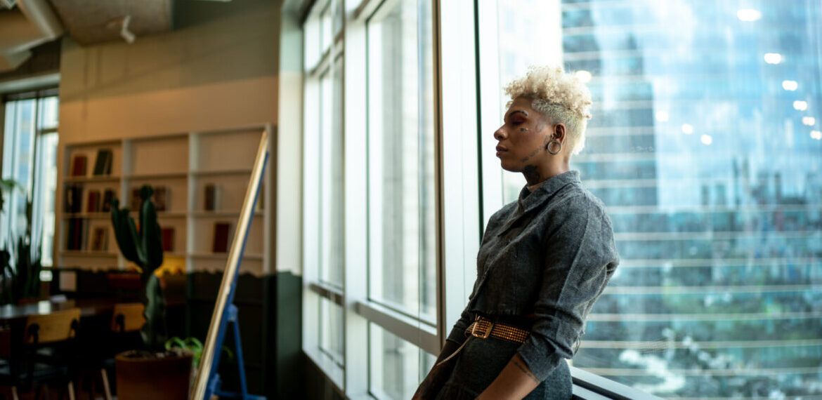 Worried woman in classroom dealing with imposter syndrome