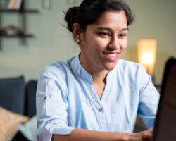 Young woman busy working on laptop at home