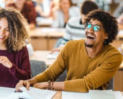 Cheerful black student having fun on a class in the classroom.