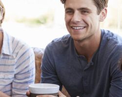 Colleagues relaxing around a table at a coffee shop, close up