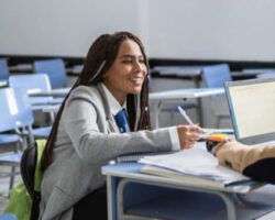 Teenager student getting feedback from a teacher in the classroom