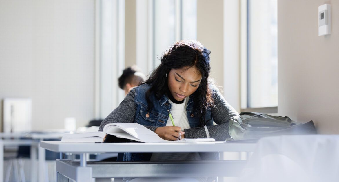 Focused young woman flip learning