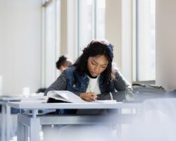 Focused young woman flip learning