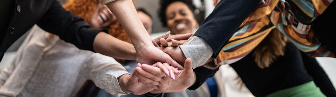 Coworkers with stacked hands at the office