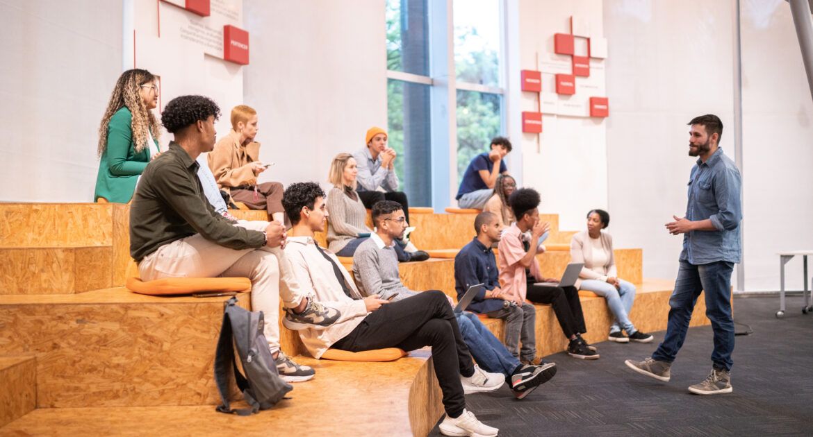 University students watching a lecture at university auditorium