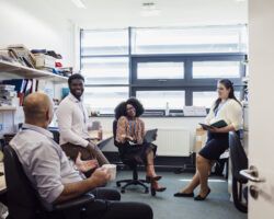 Teachers teaching in furthered education relaxing in staff room