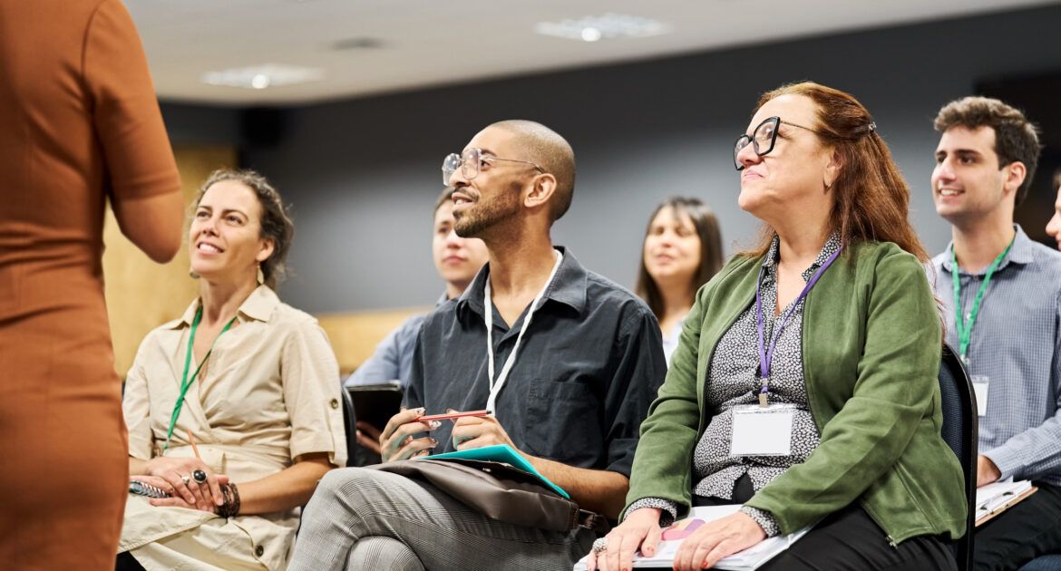 Multiracial group of businesspeople attending a conference event from a non-college training provider