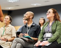 Multiracial group of businesspeople attending a conference event from a non-college training provider