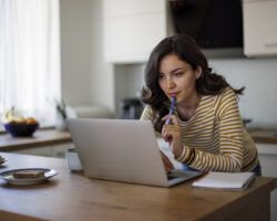 Young woman using a laptop while working from home