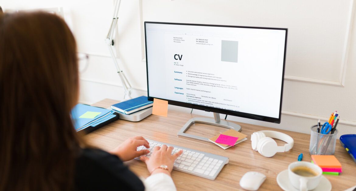 Woman seen from behind working on her new resume