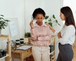 Businesswoman being consoled by her coworker at the office