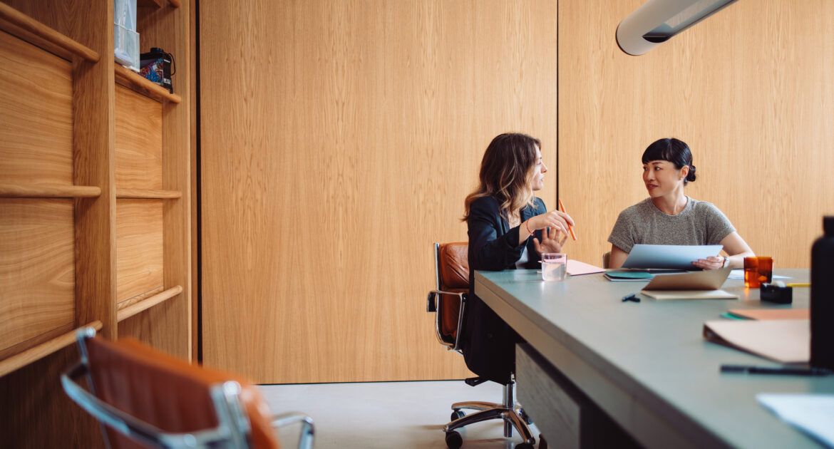 Two Businesswomen Having a Meeting in a Modern Office