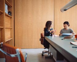 Two Businesswomen Having a Meeting in a Modern Office