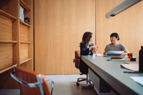 Two Businesswomen Having a Meeting in a Modern Office