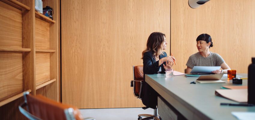 Two Businesswomen Having a Meeting in a Modern Office
