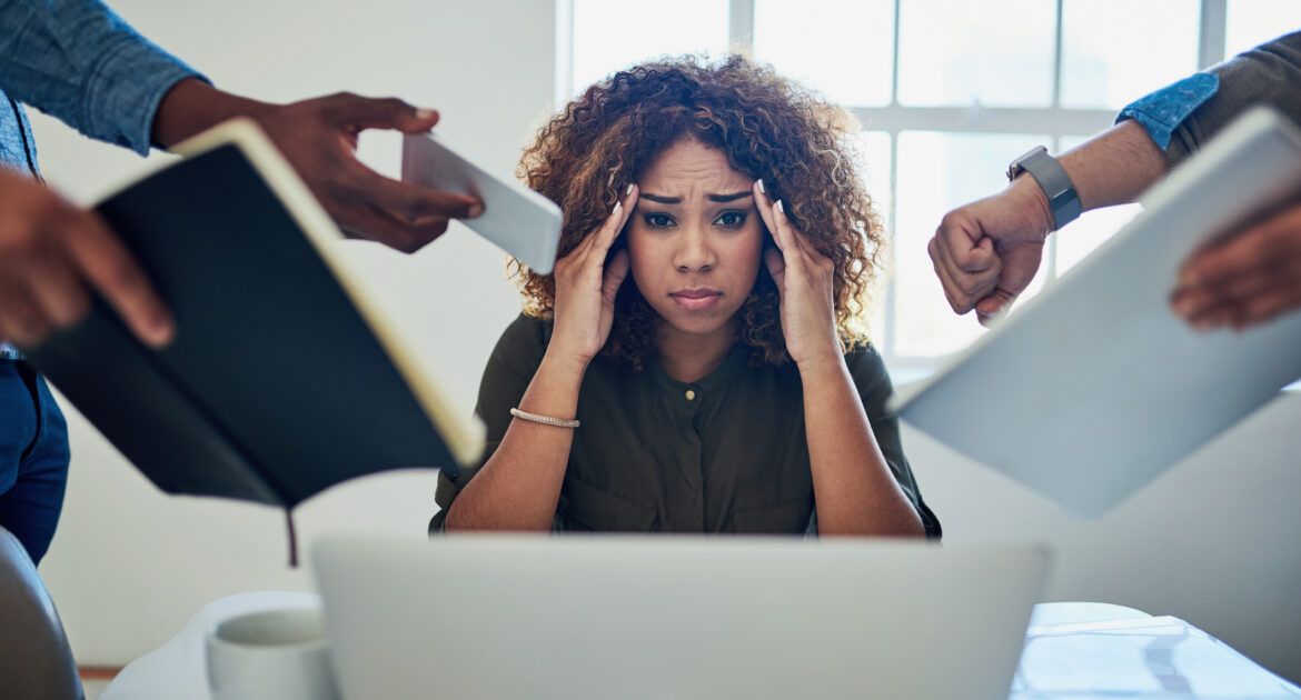 Woman stressed at work from managing the workload