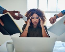 Woman stressed at work from managing the workload