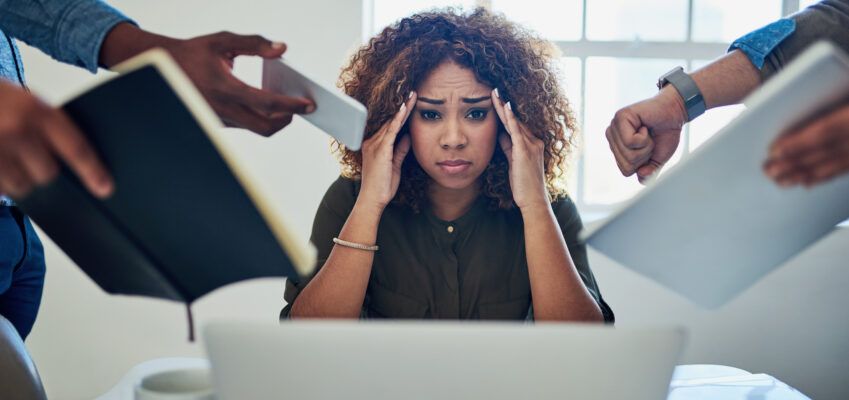 Woman stressed at work from managing the workload