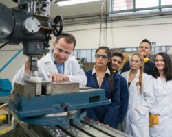 Teacher with a group of apprentices in an engineering class