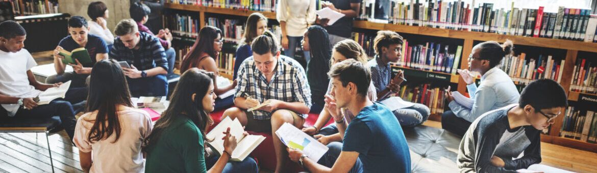 students reading in a library researching learning styles