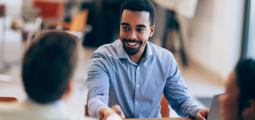 Confident man Shaking Hands During a Meeting at Modern Office