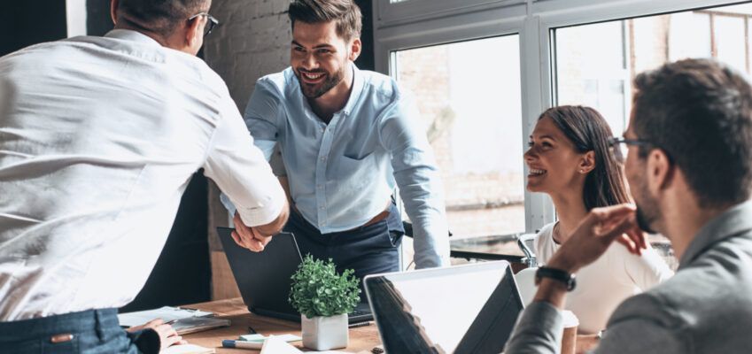 two men shaking hands after a successful job interview