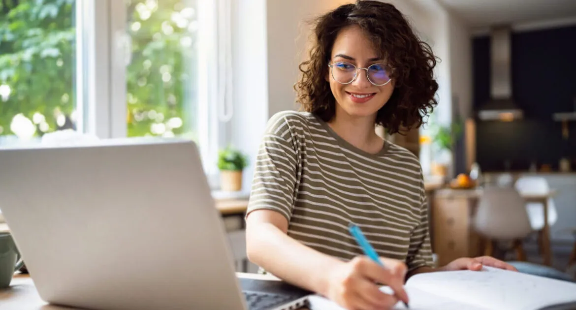 Young woman writing a Cover Letter for PhD Applications