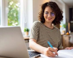 Young woman writing a Cover Letter for PhD Applications