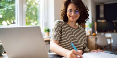 Young woman writing a Cover Letter for PhD Applications