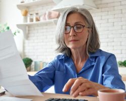 mature lady looking over paper work planning for retirement