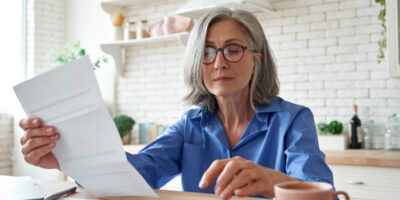 mature lady looking over paper work planning for retirement