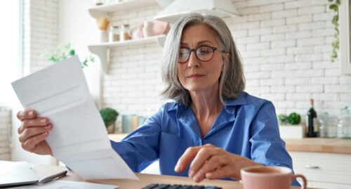 mature lady looking over paper work planning for retirement