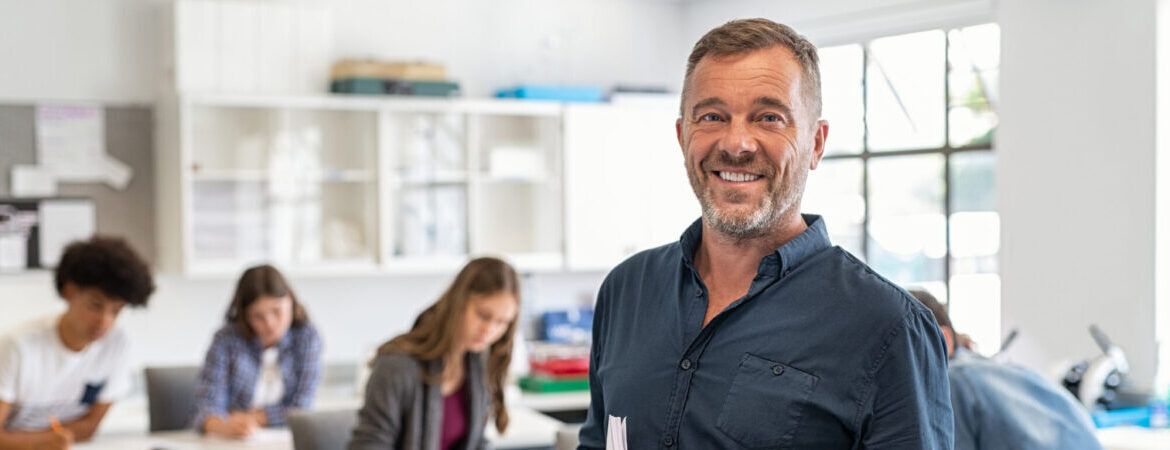 Mature man professor standing in class