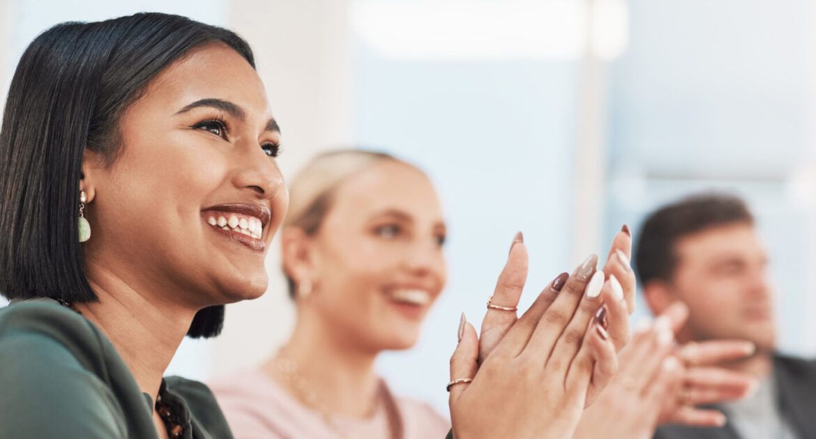 Navigate your career - Shot of a group of businesspeople clapping during a meeting in a modern office