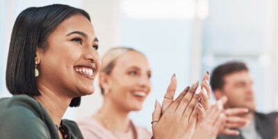 Navigate your career - Shot of a group of businesspeople clapping during a meeting in a modern office