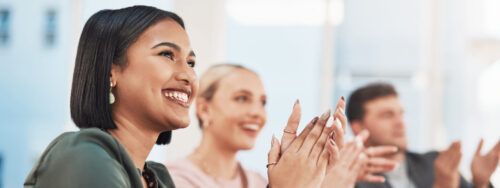 Navigate your career - Shot of a group of businesspeople clapping during a meeting in a modern office