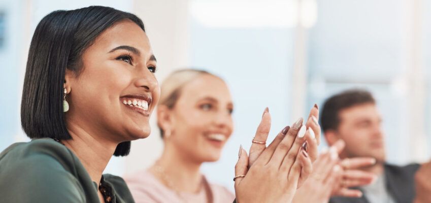 Navigate your career - Shot of a group of businesspeople clapping during a meeting in a modern office