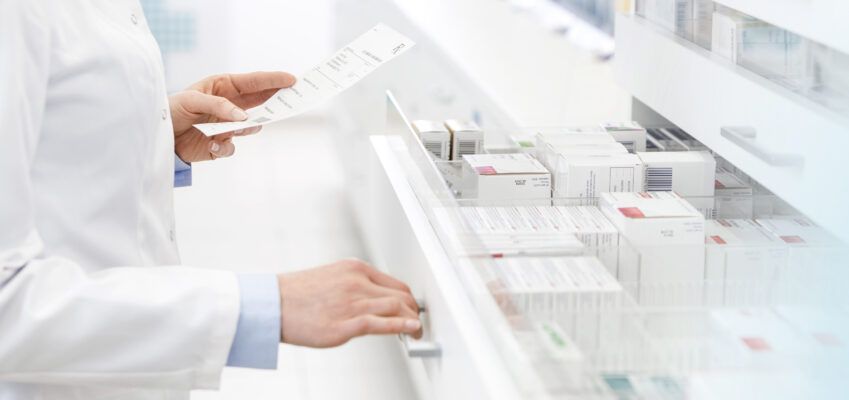 Pharmacist filling prescription in pharmacy