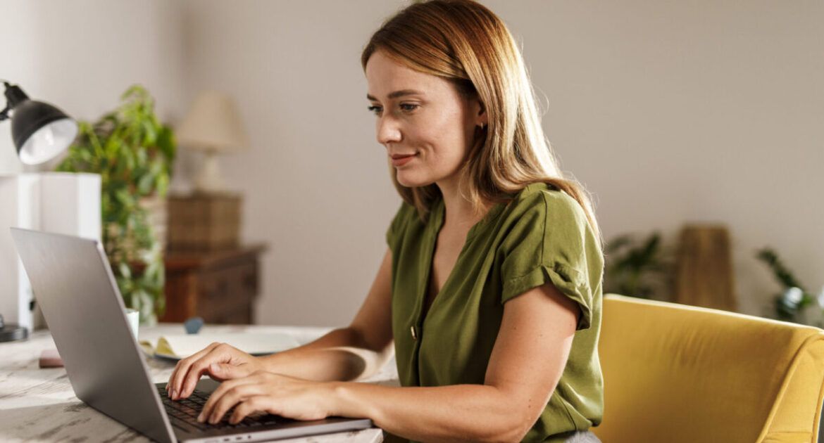 Woman using laptop when working from home office