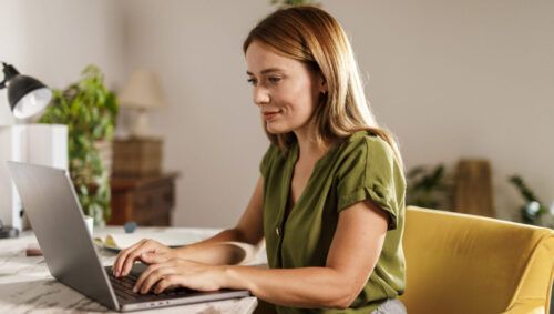 Woman using laptop when working from home office