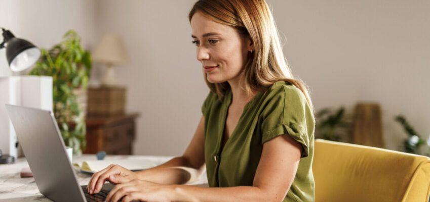 Woman using laptop when working from home office