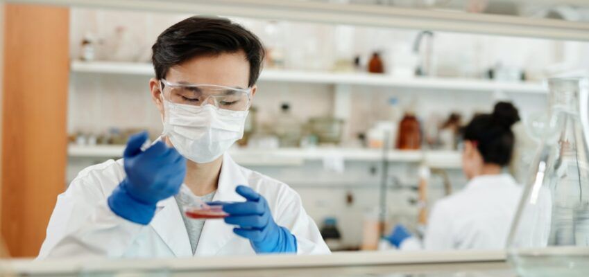 male scientist conducting experiment