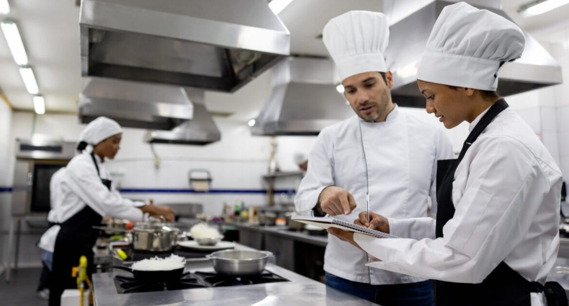 Chef talking to a student in a cooking class